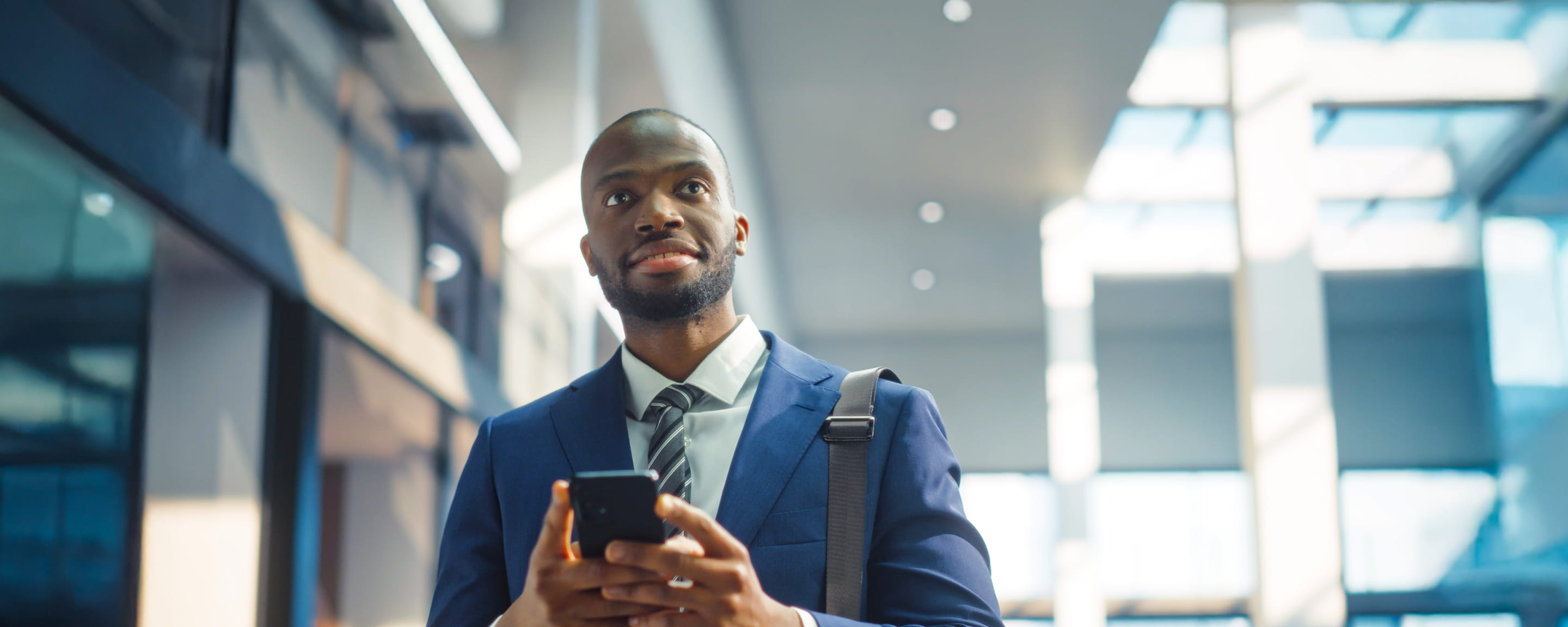 Man using his mobile phone on his way to the office