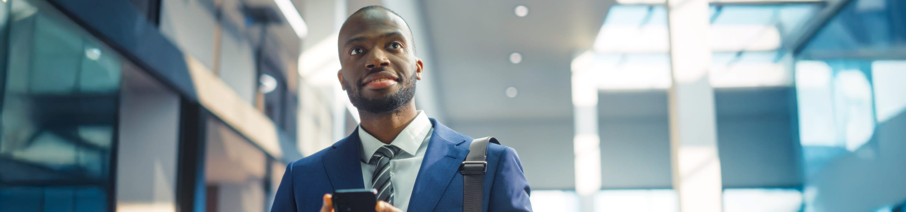 Man using his mobile phone on his way to the office