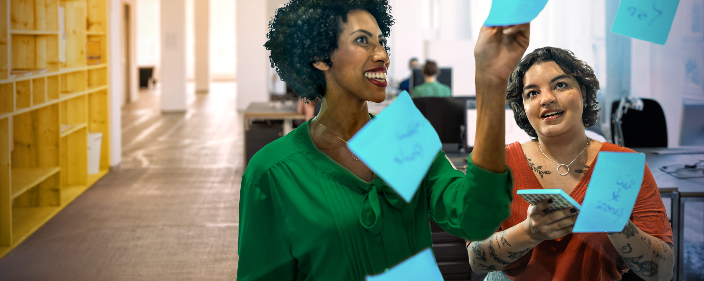 people working together in an office with post-it notes