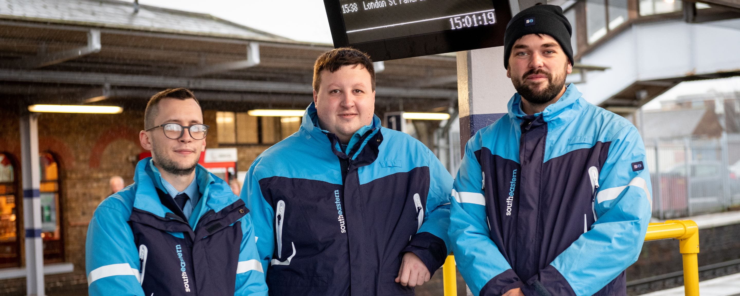 three male colleagues on a platform