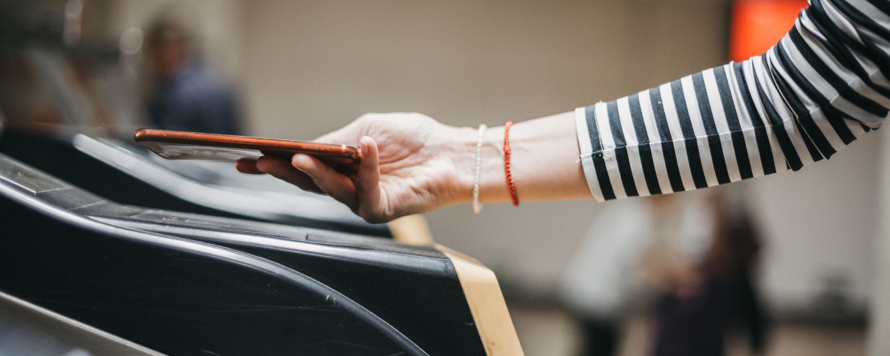 a person using their phone to tap in at a station