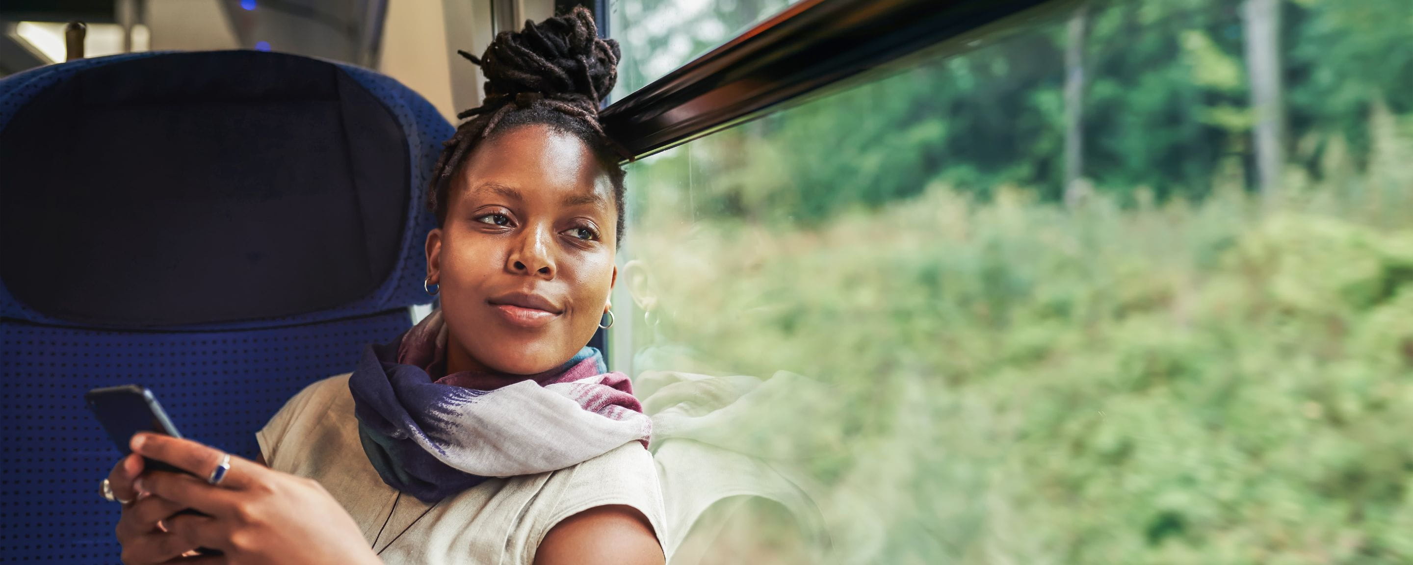 woman on a train using her mobile phone