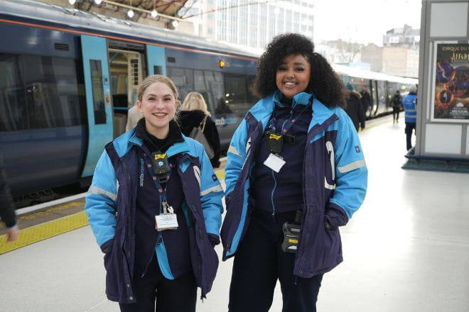 two Southeastern colleagues smiling on a platform