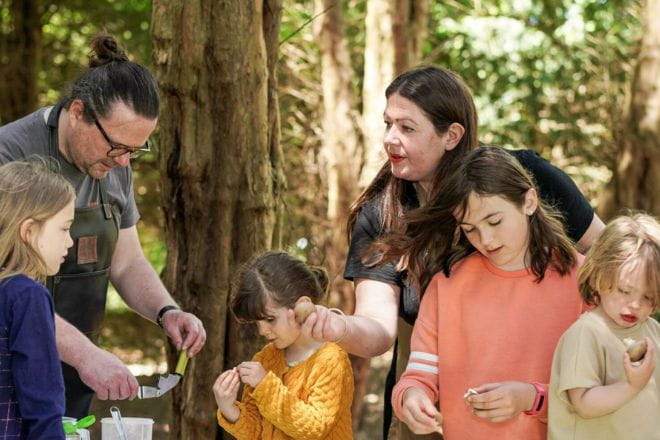 Family in the woods doing arts & crafts